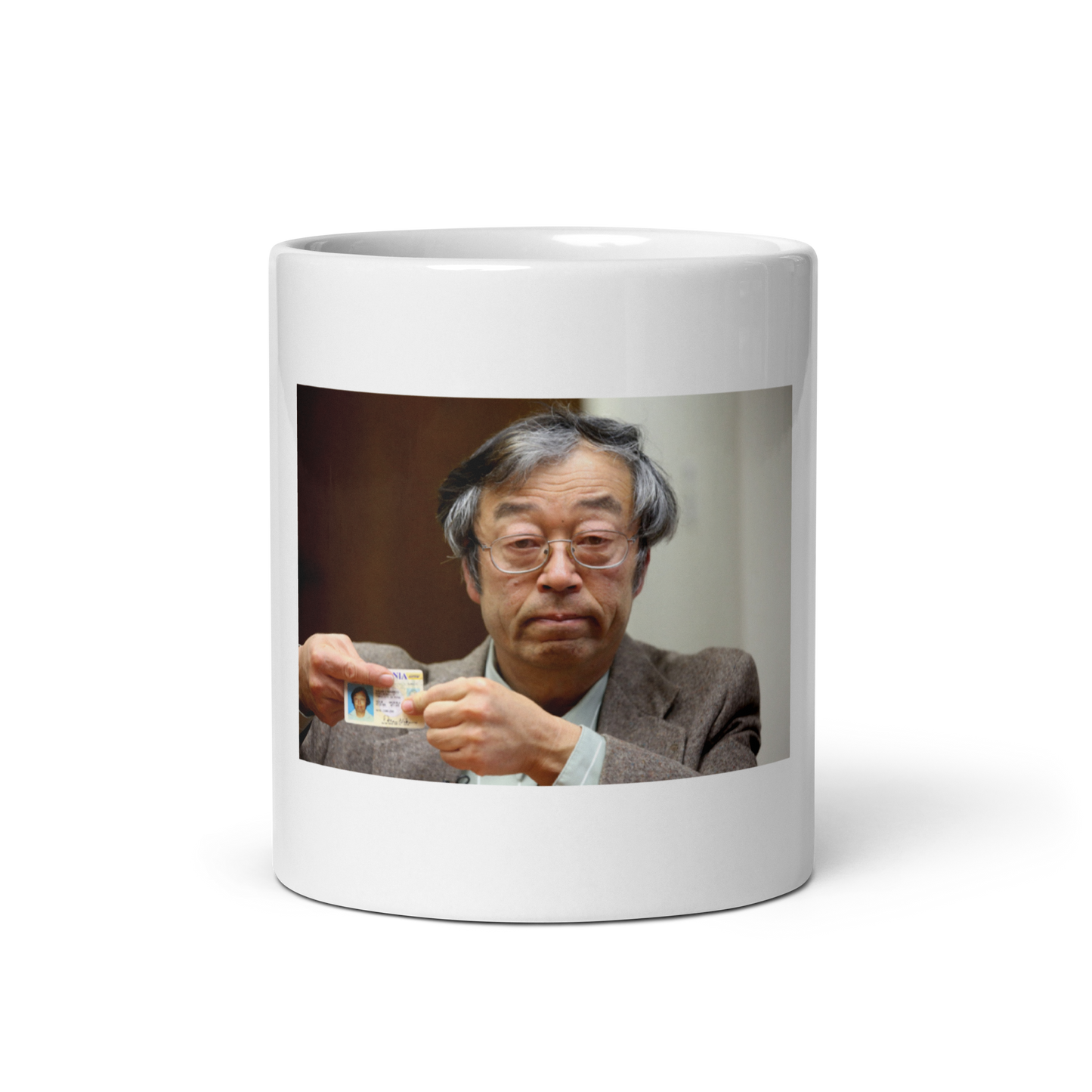 Product Image of a photograph showing Dorian Nakamoto, the accidental Satoshi legend, a sleek white glossy mug from Troll Social Club. Perfect for crypto enthusiasts and meme lovers