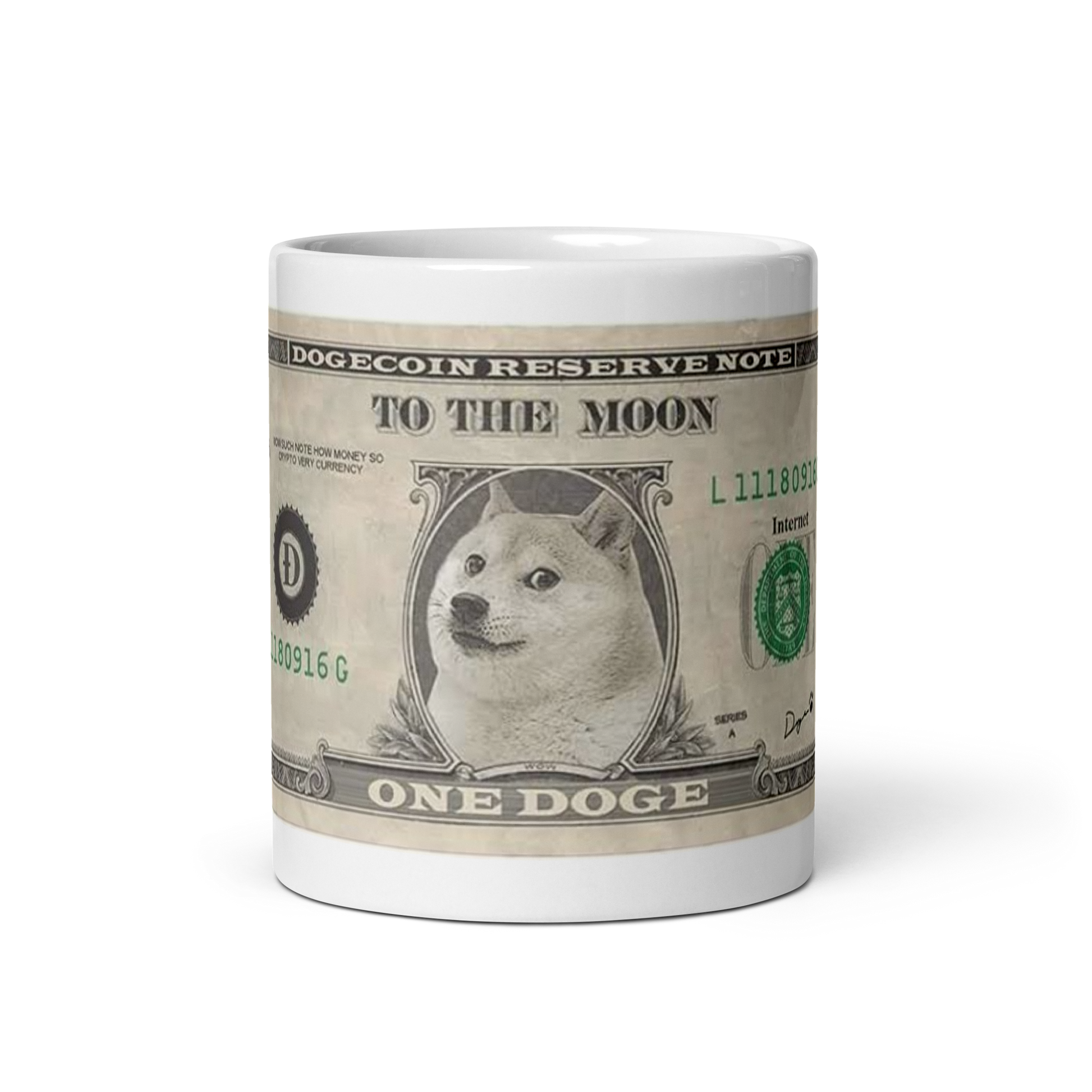 Image of a white ceramic mug featuring the 'Doge Bill' design. The design mimics a U.S. one-dollar bill but replaces George Washington with the iconic Shiba Inu Doge meme. The text on the mug reads 'DOGECOIN RESERVE NOTE' at the top, 'TO THE MOON' in the center, and 'ONE DOGE' at the bottom. The serial number 'L11180916G' is visible, along with the seal of the Dogecoin Reserve in green, and the word 'Internet' instead of 'Washington, D.C.' on the right side. This mug is a humorous tribute to Dogecoin