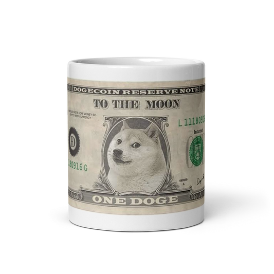 Image of a white ceramic mug featuring the 'Doge Bill' design. The design mimics a U.S. one-dollar bill but replaces George Washington with the iconic Shiba Inu Doge meme. The text on the mug reads 'DOGECOIN RESERVE NOTE' at the top, 'TO THE MOON' in the center, and 'ONE DOGE' at the bottom. The serial number 'L11180916G' is visible, along with the seal of the Dogecoin Reserve in green, and the word 'Internet' instead of 'Washington, D.C.' on the right side. This mug is a humorous tribute to Dogecoin